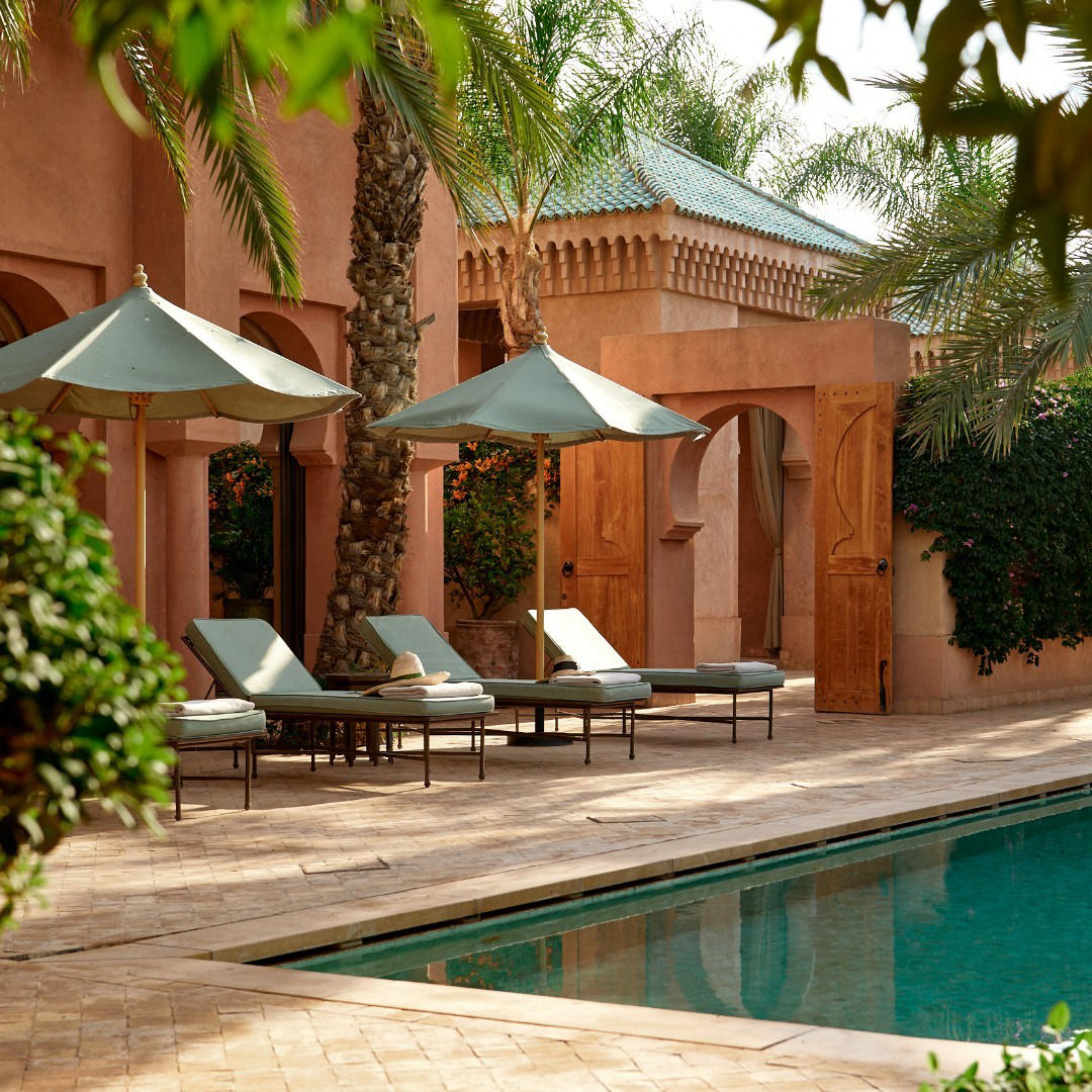 Sun loungers soak up the sun, as the surface of the Al-Hamra Maison’s private heated pool shimmers i